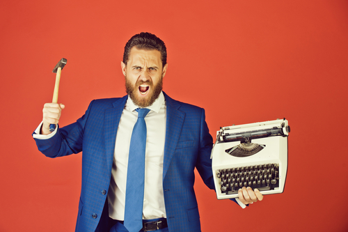 business man, aggressive businessman with typewriter and hammer