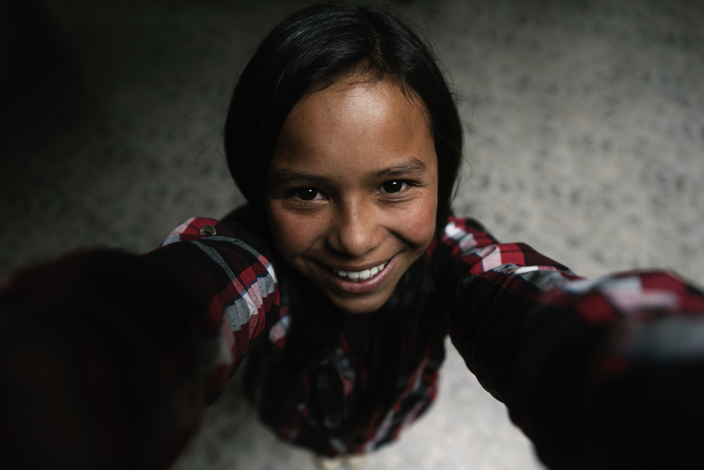 Self portrait of beautiful girl in shanty town.